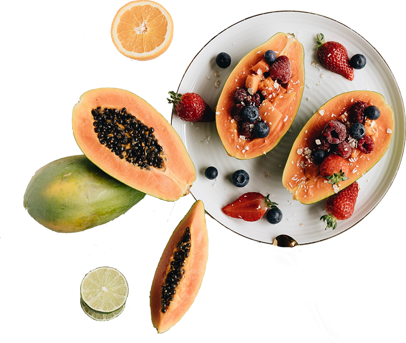 Fresh organic papaya stuffed with berries on a plate.